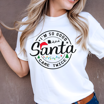 Woman wearing a funny white Christmas t-shirt with 'I'm so good Santa came twice' text design.