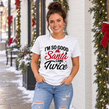 Woman wearing a white T-shirt with the funny I'm So Good Santa Came Twice holiday design.