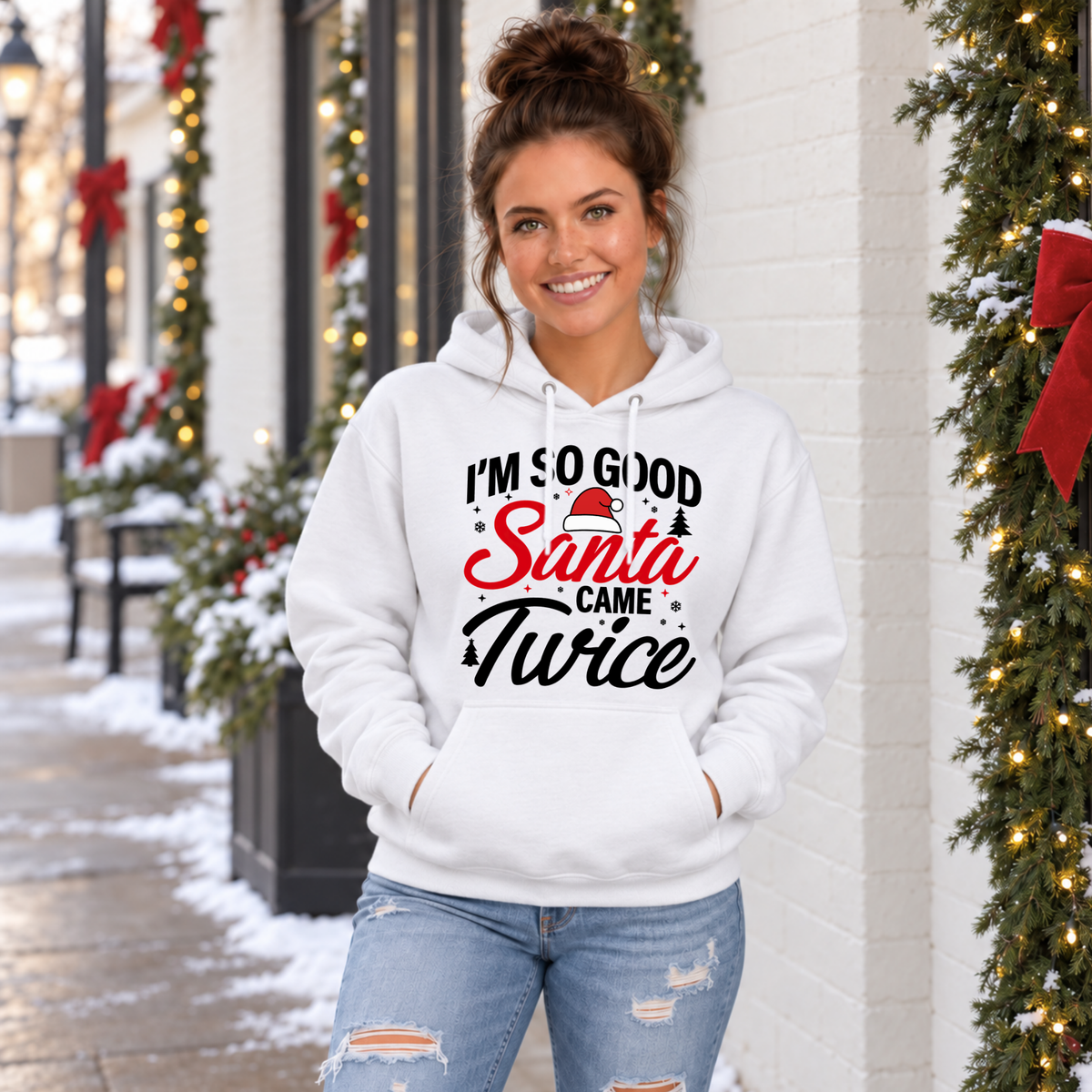 Woman modeling a white hoodie with the I'm So Good Santa Came Twice Christmas graphic.