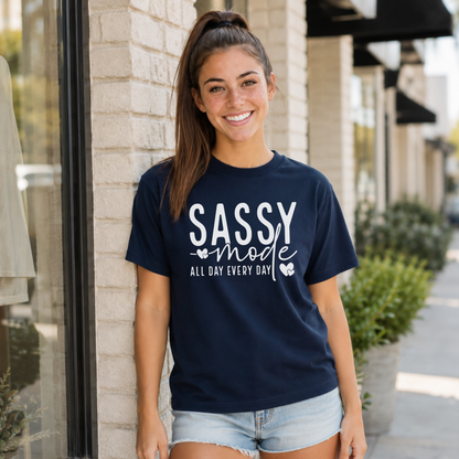 Woman wearing a navy Sassy Mode T-shirt with white lettering outside a storefront.