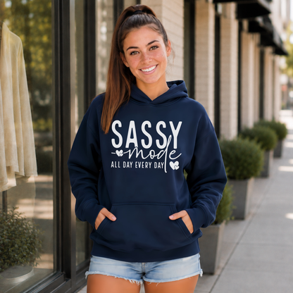 Woman wearing a navy Sassy Mode hoodie with white lettering outside a storefront.