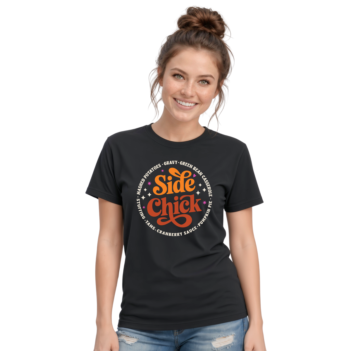 A woman models a Black T-shirt with the retro “Side Chick” Thanksgiving graphic in orange and light lettering, surrounded by classic side-dish names, against a clean white background.