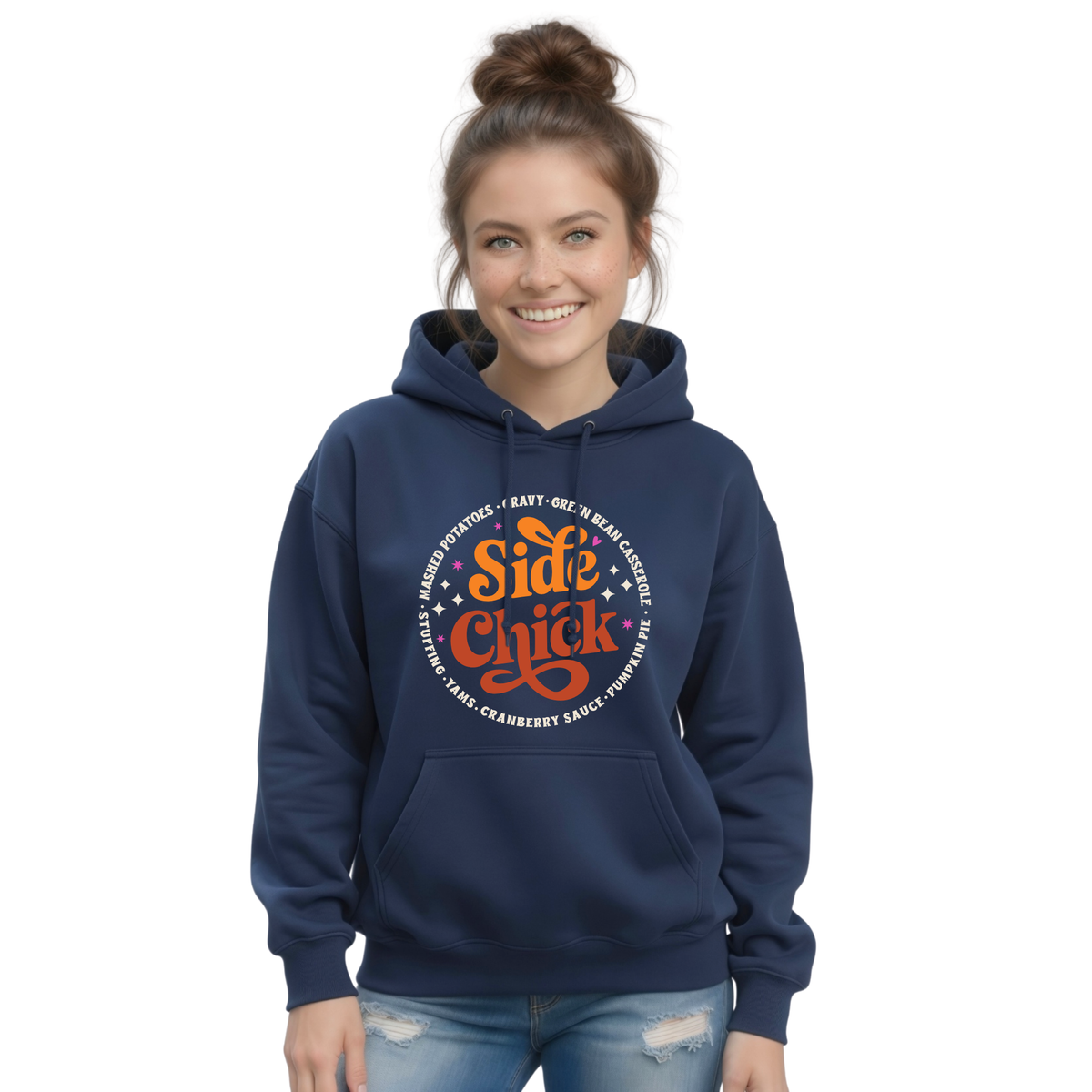 A woman models a Navy pullover hoodie with the retro “Side Chick” Thanksgiving graphic, featuring bright lettering and a ring of classic side-dish names on a white background.