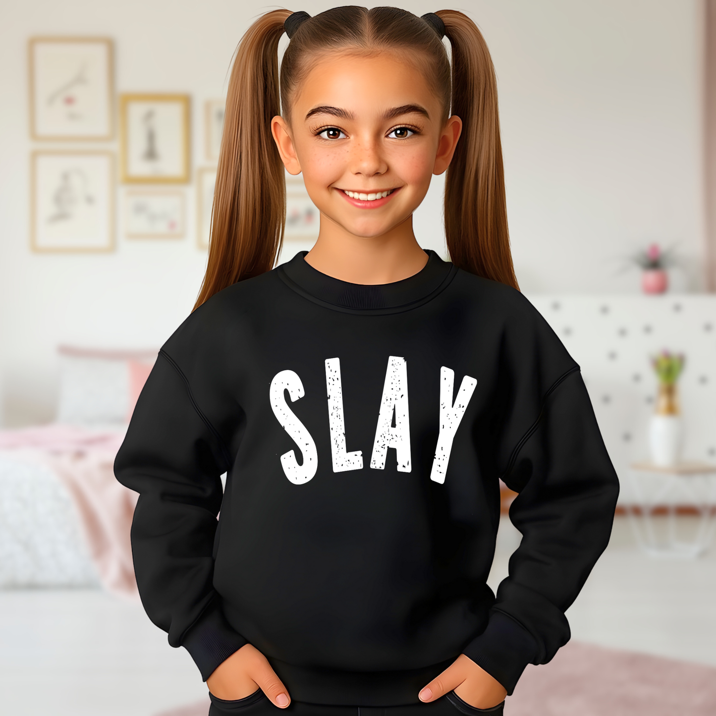 Girl modeling black SLAY youth sweatshirt in bedroom