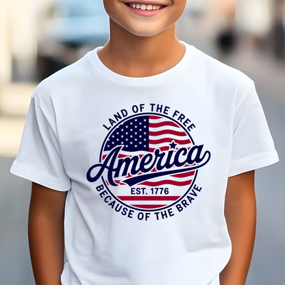 Smiling youth boy in white t-shirt featuring USA flag and “America Est. 1776” print