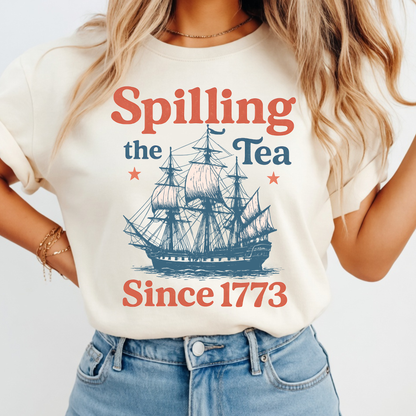 Woman wearing a t-shirt with a ship graphic and text 'Spilling the Tea Since 1773' on a plain background