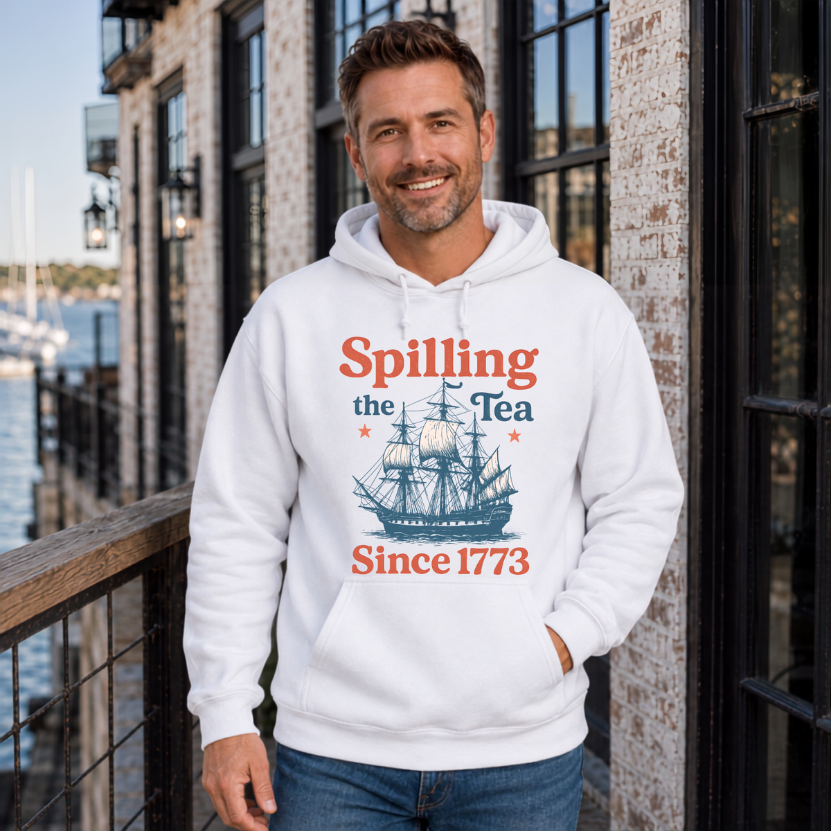 White hoodie featuring the Spilling the Tea Since 1773 vintage ship graphic and patriotic history design.