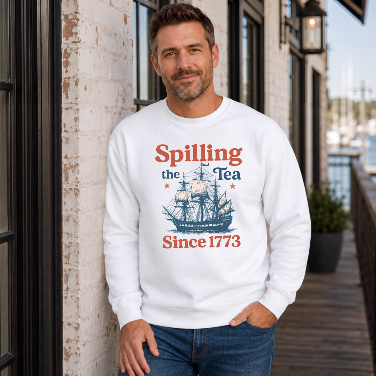 White crewneck sweatshirt featuring the Spilling the Tea Since 1773 patriotic vintage ship graphic.