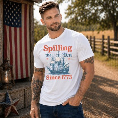 Man wearing a white t-shirt with a ship graphic and text, standing outdoors with an American flag in the background.