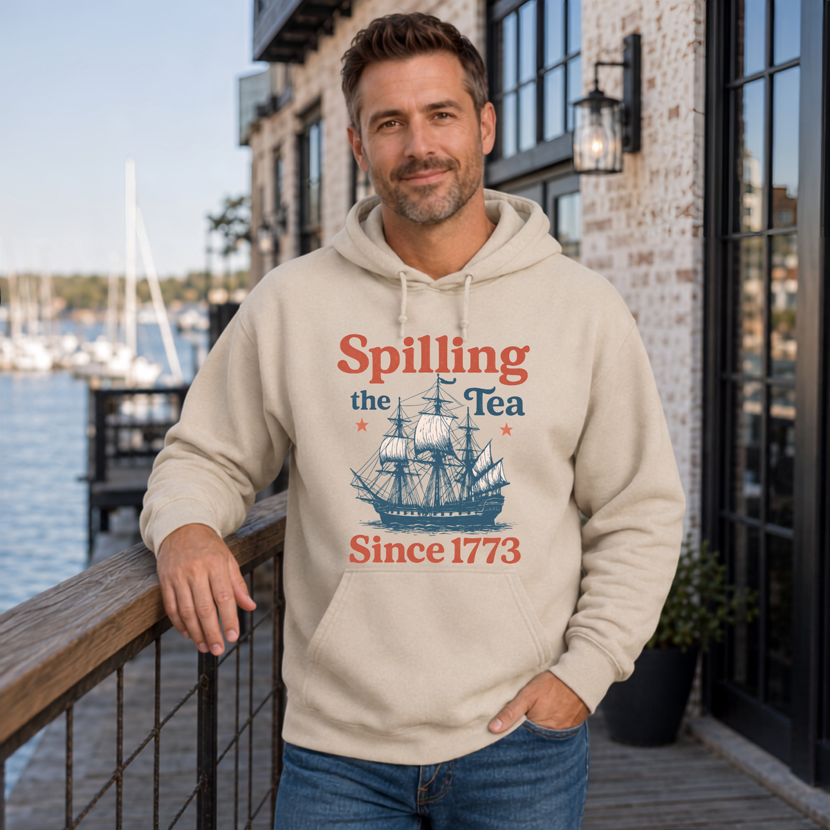 Sand hoodie featuring the Spilling the Tea Since 1773 vintage ship graphic and patriotic history theme.