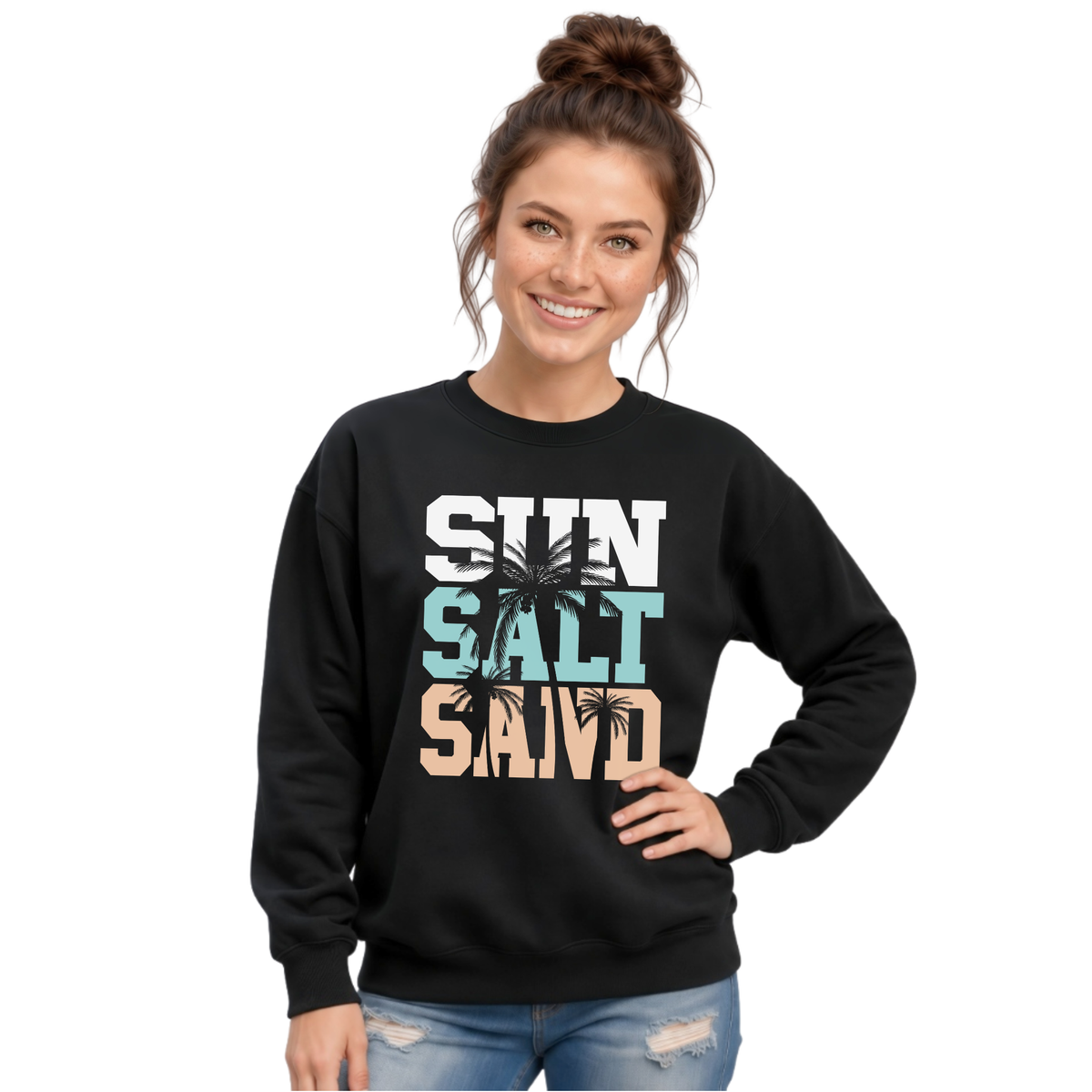 Woman wearing a black crewneck sweatshirt with a stacked Sun Salt Sand graphic in white, aqua, and peach with dark palm trees.