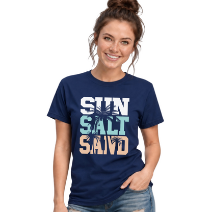 Woman wearing a navy unisex T-shirt with a stacked Sun Salt Sand graphic in white, aqua, and peach with dark palm trees.