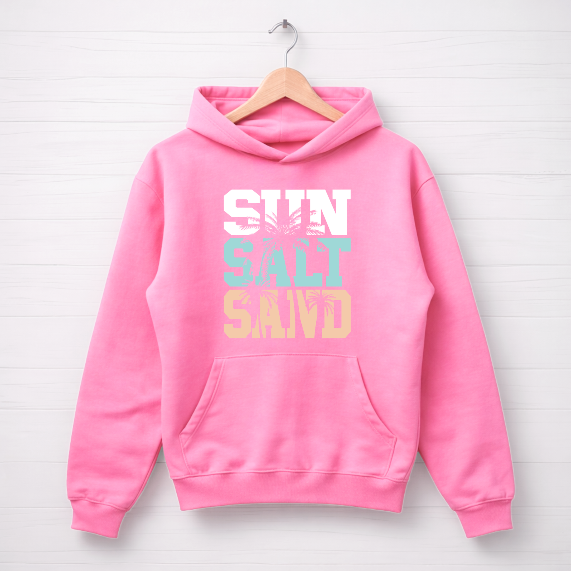 Pink hoodie with 'SUN SALT SAND' text on a white background