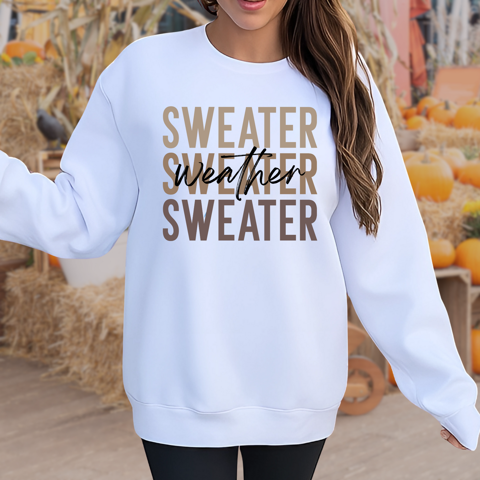 “Woman wearing a white Sweater Weather sweatshirt in a pumpkin patch. Cozy unisex crewneck for fall fashion, perfect for outdoor autumn events and casual holiday outfits.