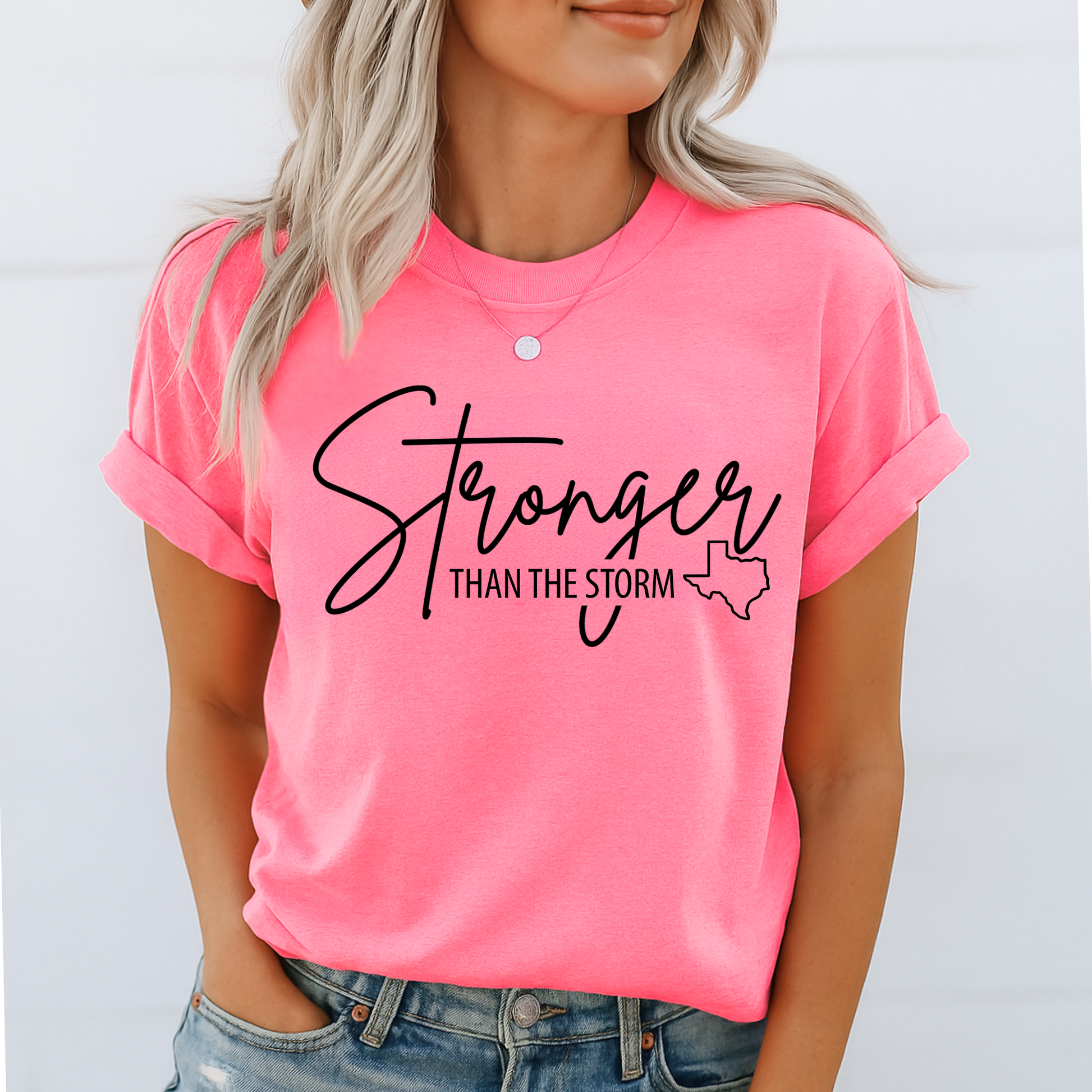 Bright hot pink women's "Stronger Than the Storm" Texas charity T-shirt with bold black graphic, storm relief donation shirt, summer fit.