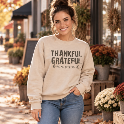 Woman wearing a sand crewneck sweatshirt with Thankful Grateful Blessed text outside a fall storefront.