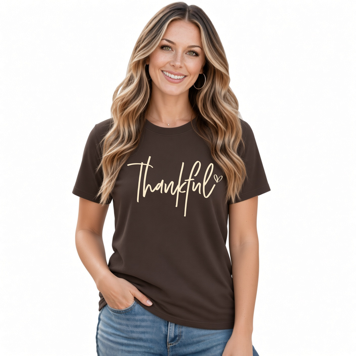 Woman wearing a brown T-shirt with a white Thankful script design and blue jeans