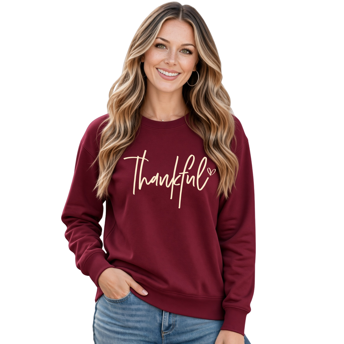 Woman modeling a maroon crewneck sweatshirt with a cream Thankful script design on a white background