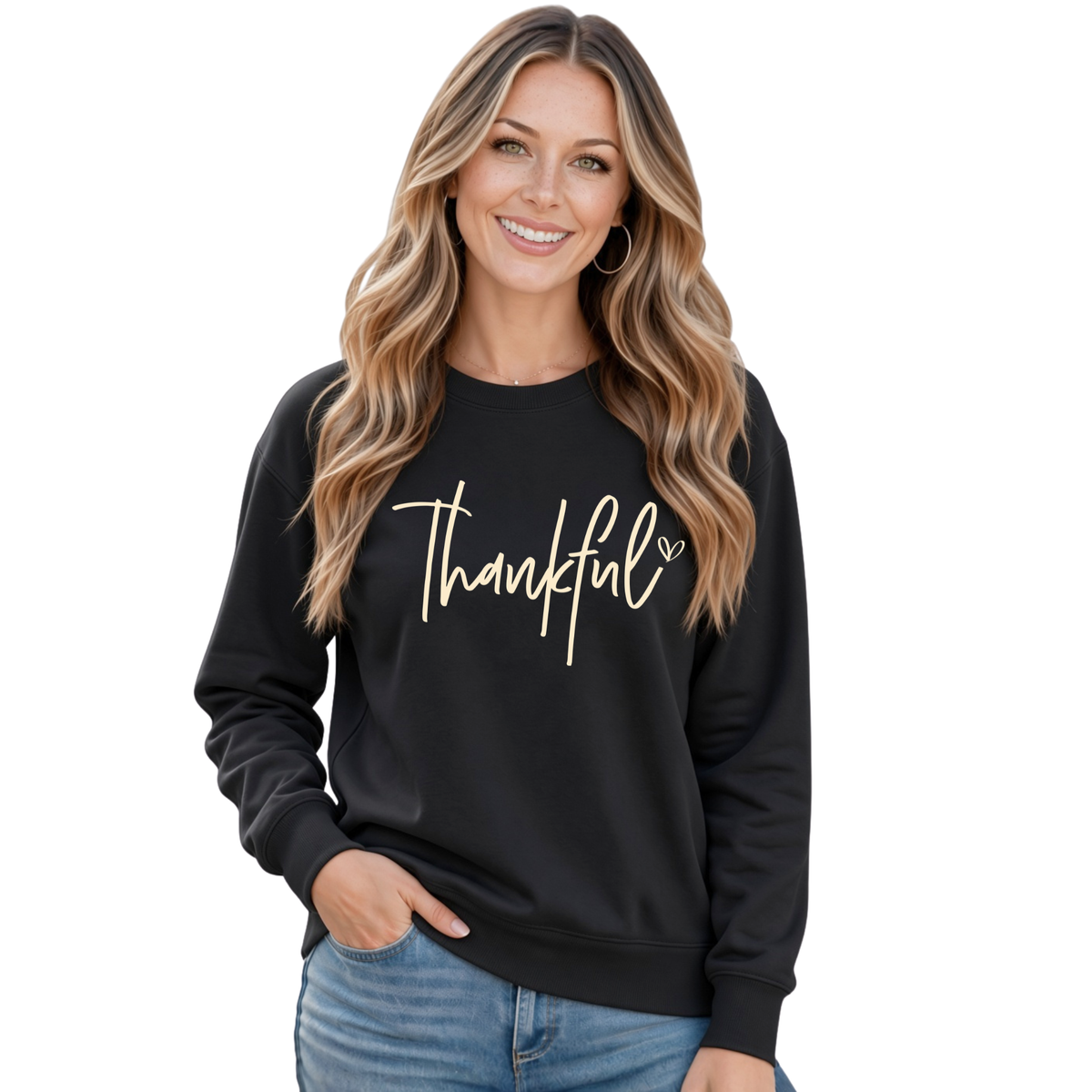 Woman wearing a black crewneck sweatshirt with a white Thankful script design and blue jeans