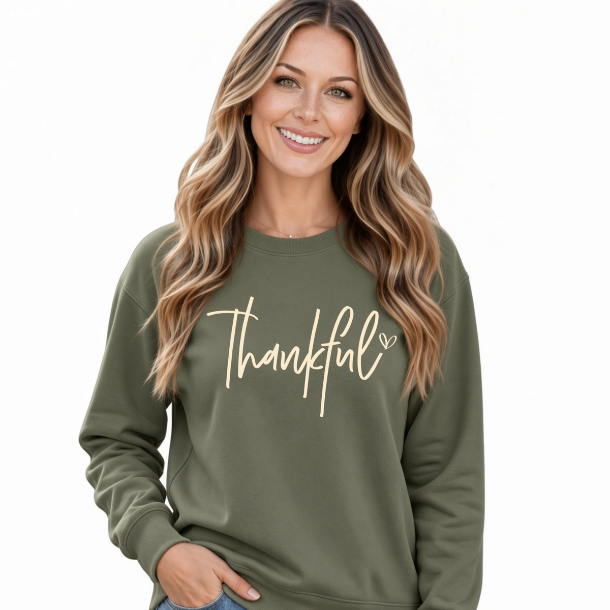 Woman modeling a military green crewneck sweatshirt with a cream Thankful script design on a white background