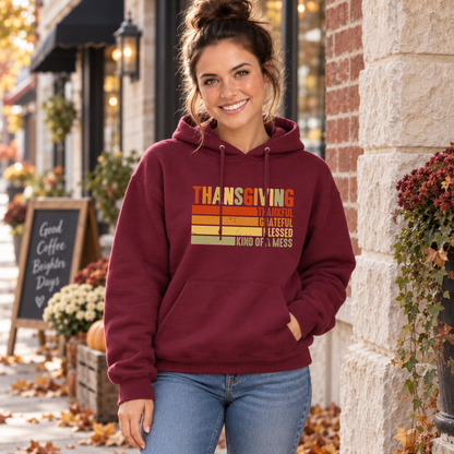 Woman wearing a maroon hoodie with retro Thanksgiving Kind of a Mess design outside a storefront decorated for fall.