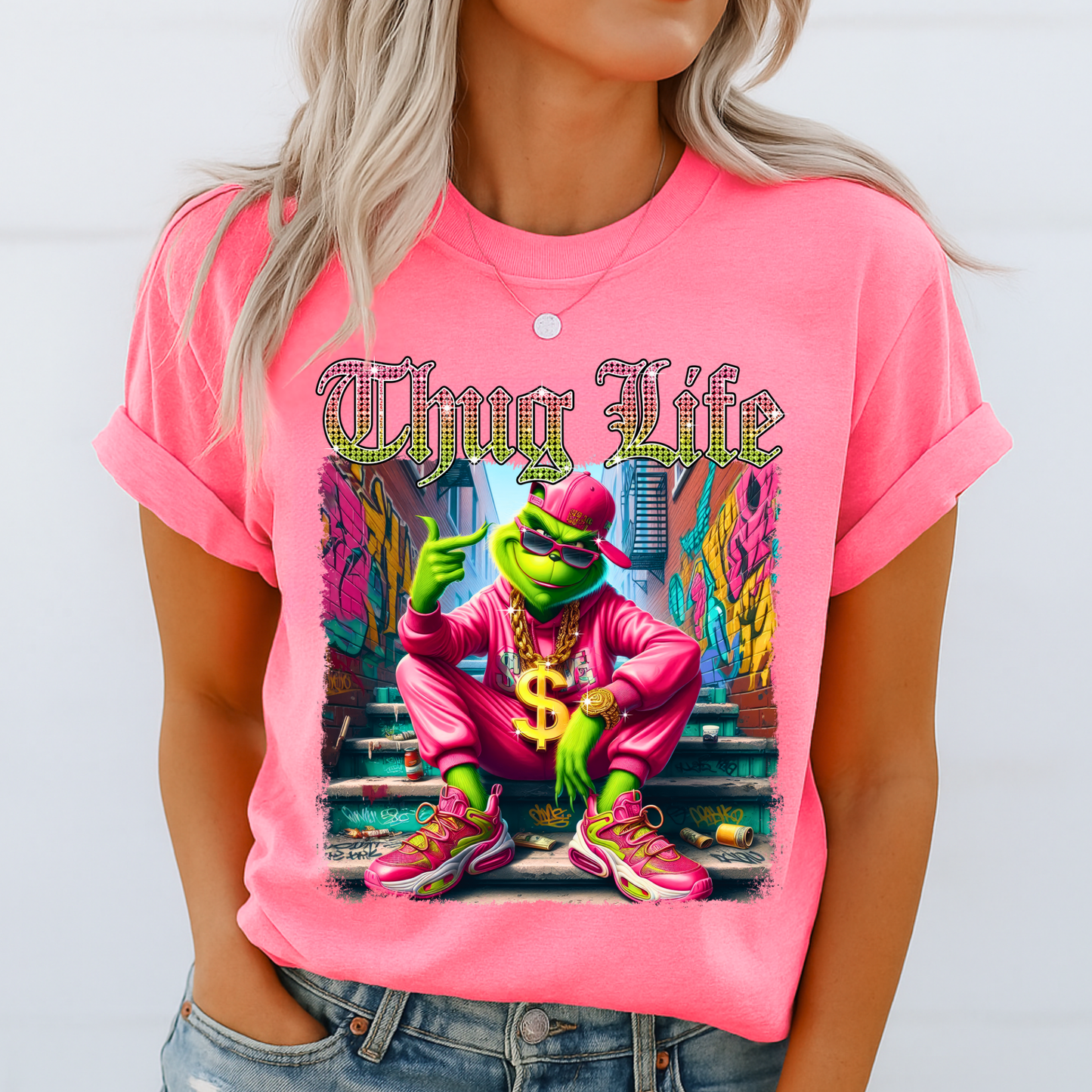 Bright pink unisex t-shirt with bold Thug Life street art graphic, colorful character design, casual outfit photo.