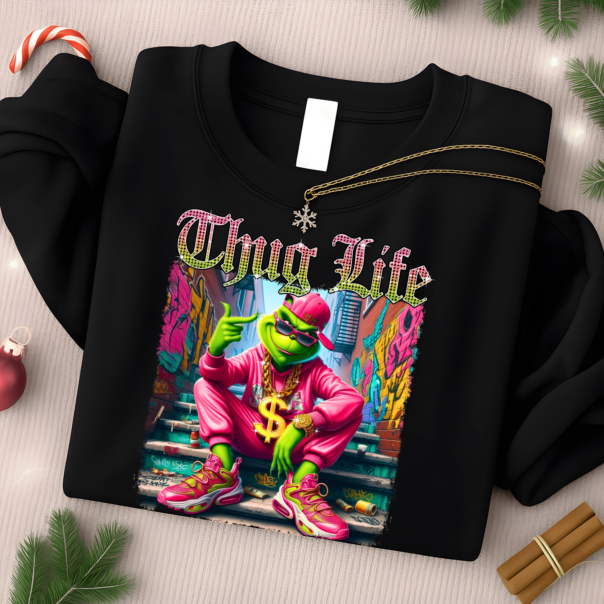 Black sweatshirt with neon Thug Life street style print shown in Christmas themed flat lay.