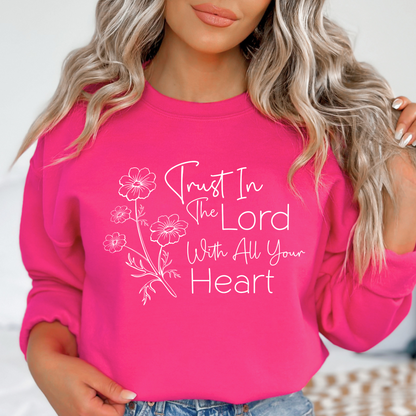 Woman wearing dark Pink sweatshirt with floral graphic and “Trust in the Lord With All Your Heart” text.