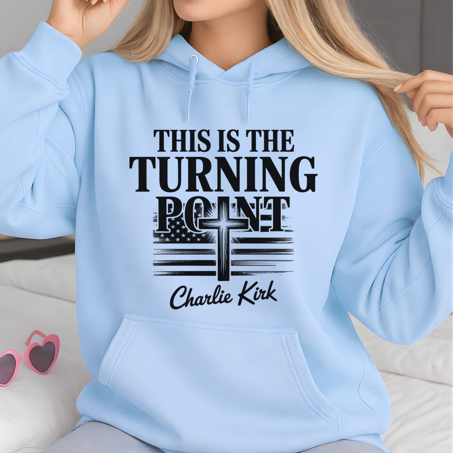 Model wearing light blue hoodie featuring Turning Point Christian faith cross and American flag graphic