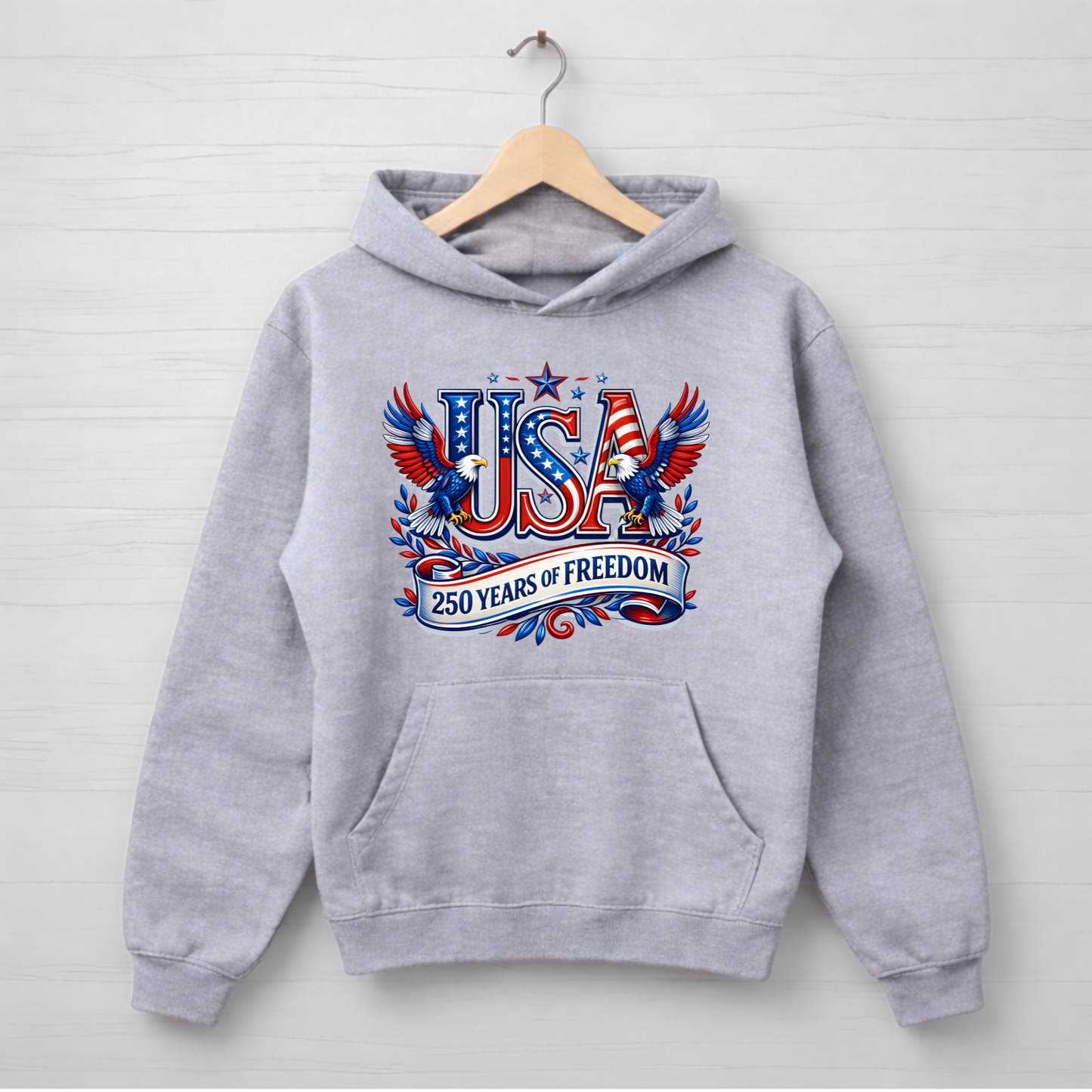 Gray hoodie with 'USA 250 Years of Freedom' design on a wooden hanger against a light gray background