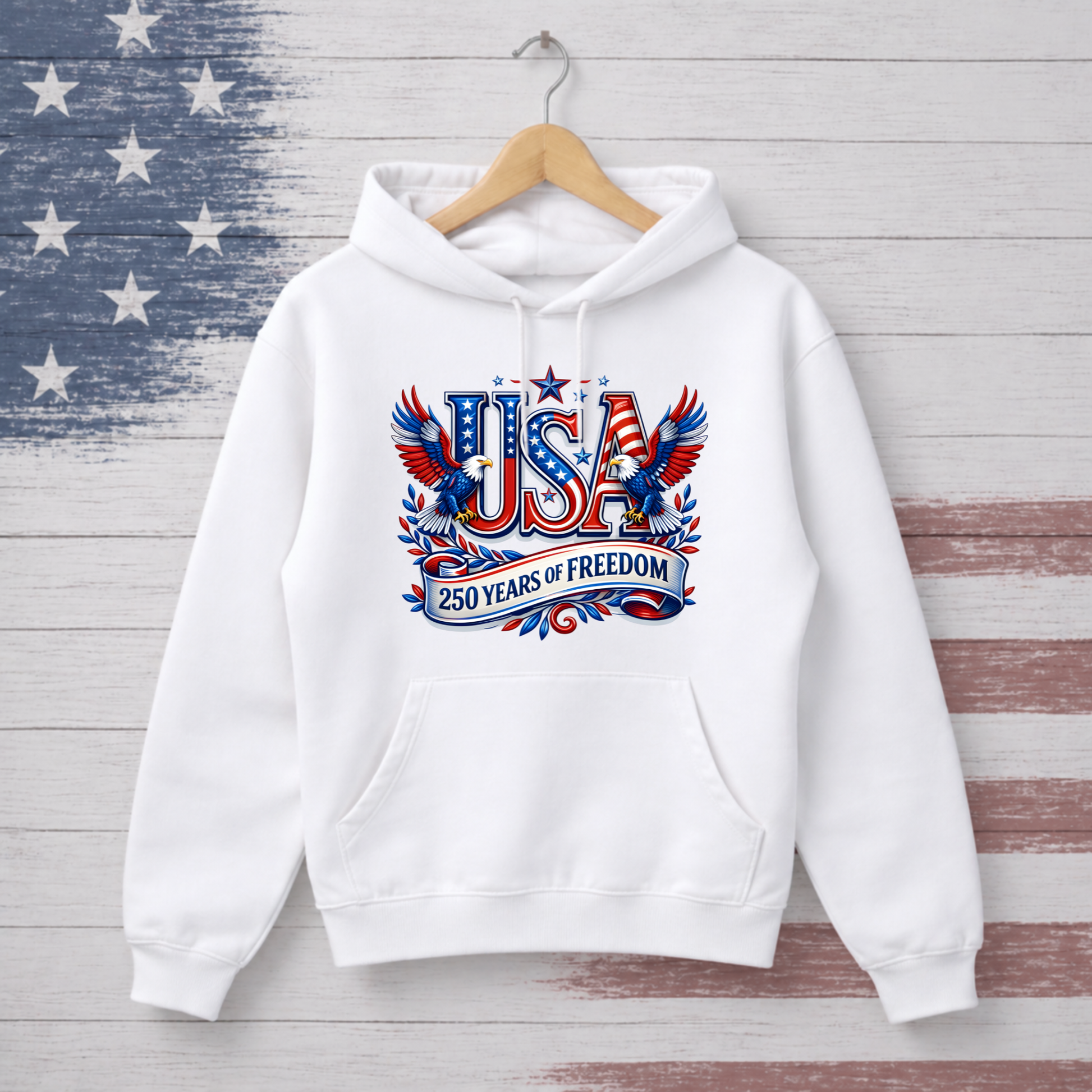 White hoodie with 'USA 250 Years of Freedom' design on a wooden background with American flag pattern
