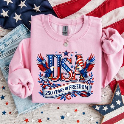 Pink sweatshirt with 'USA 250 Years of Freedom' design on an American flag background