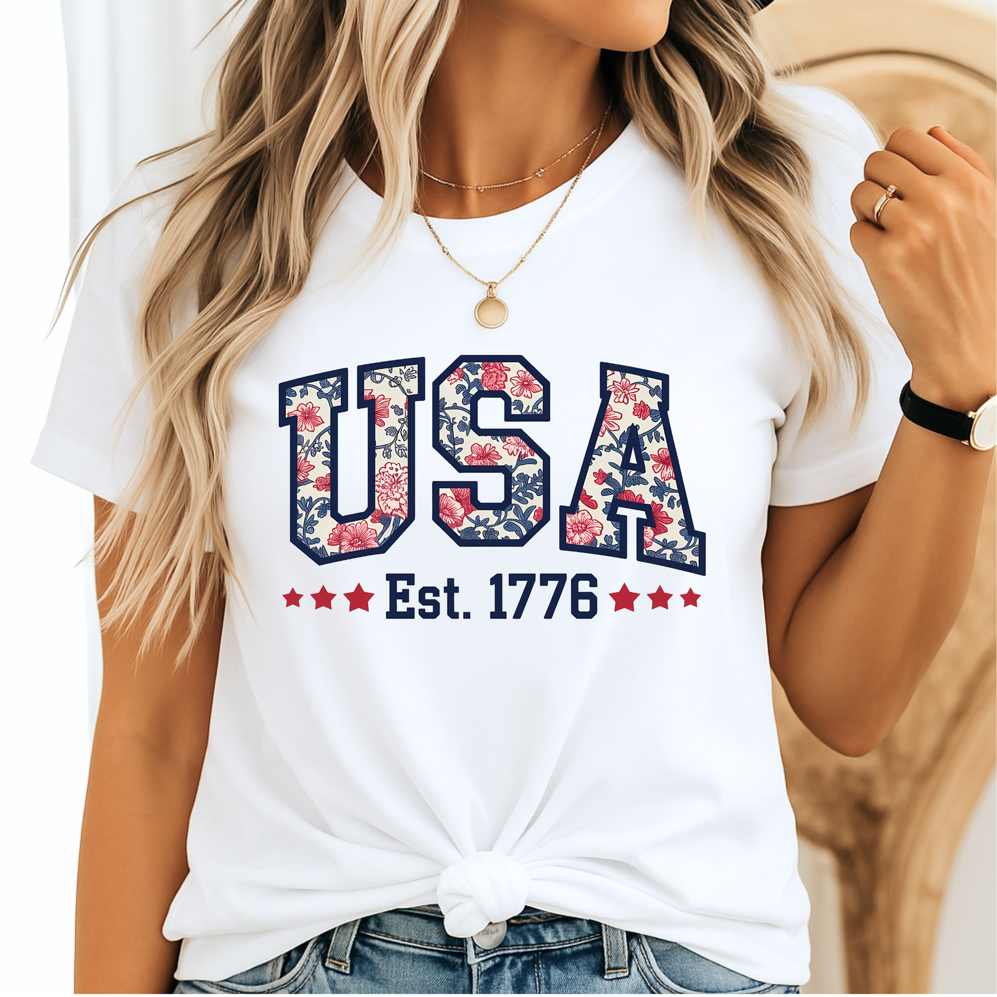 White USA floral patriotic tee with Est. 1776 – styled with a knotted hem and casual accessories.

