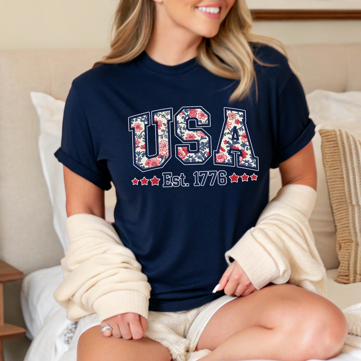 Navy blue USA Est. 1776 T-shirt with floral letters – perfect for Memorial Day or patriotic events.


