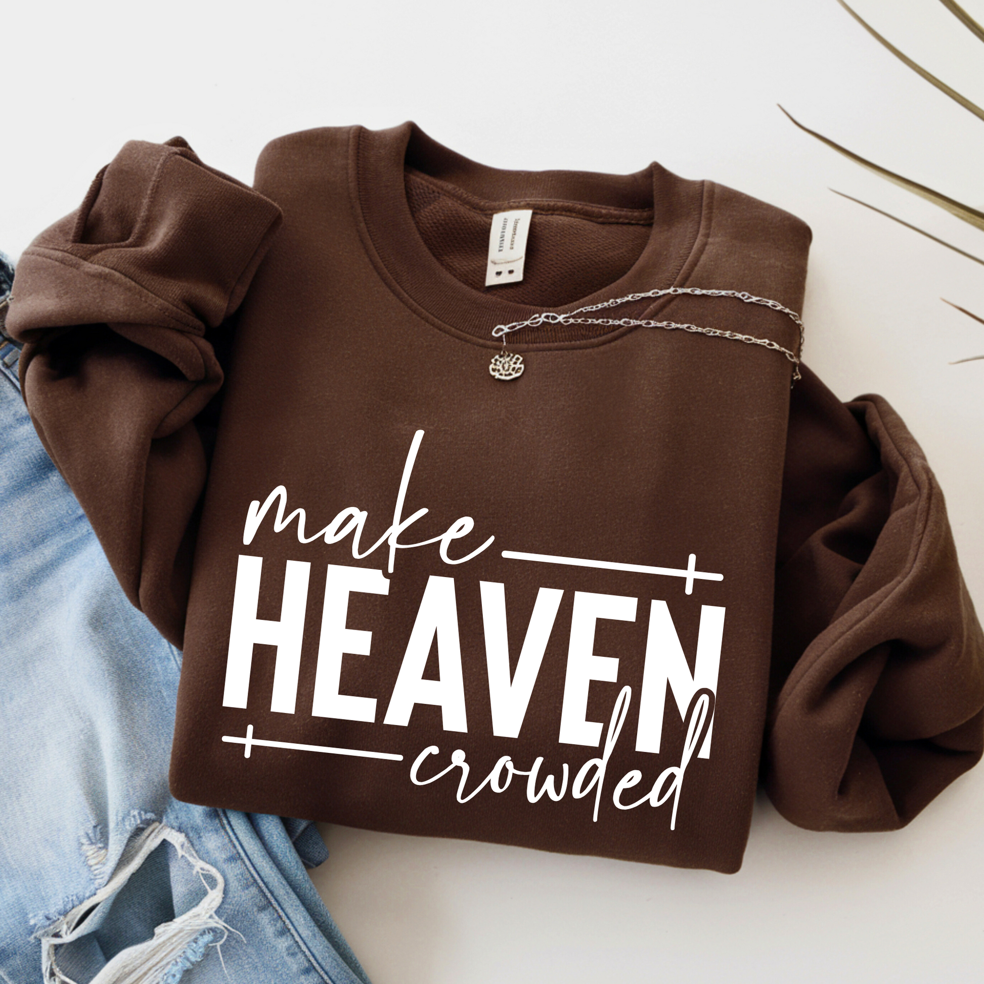 Brown Make Heaven Crowded sweatshirt flat lay with denim