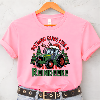 Pink t-shirt with Christmas tractor graphic and text on a hanger
