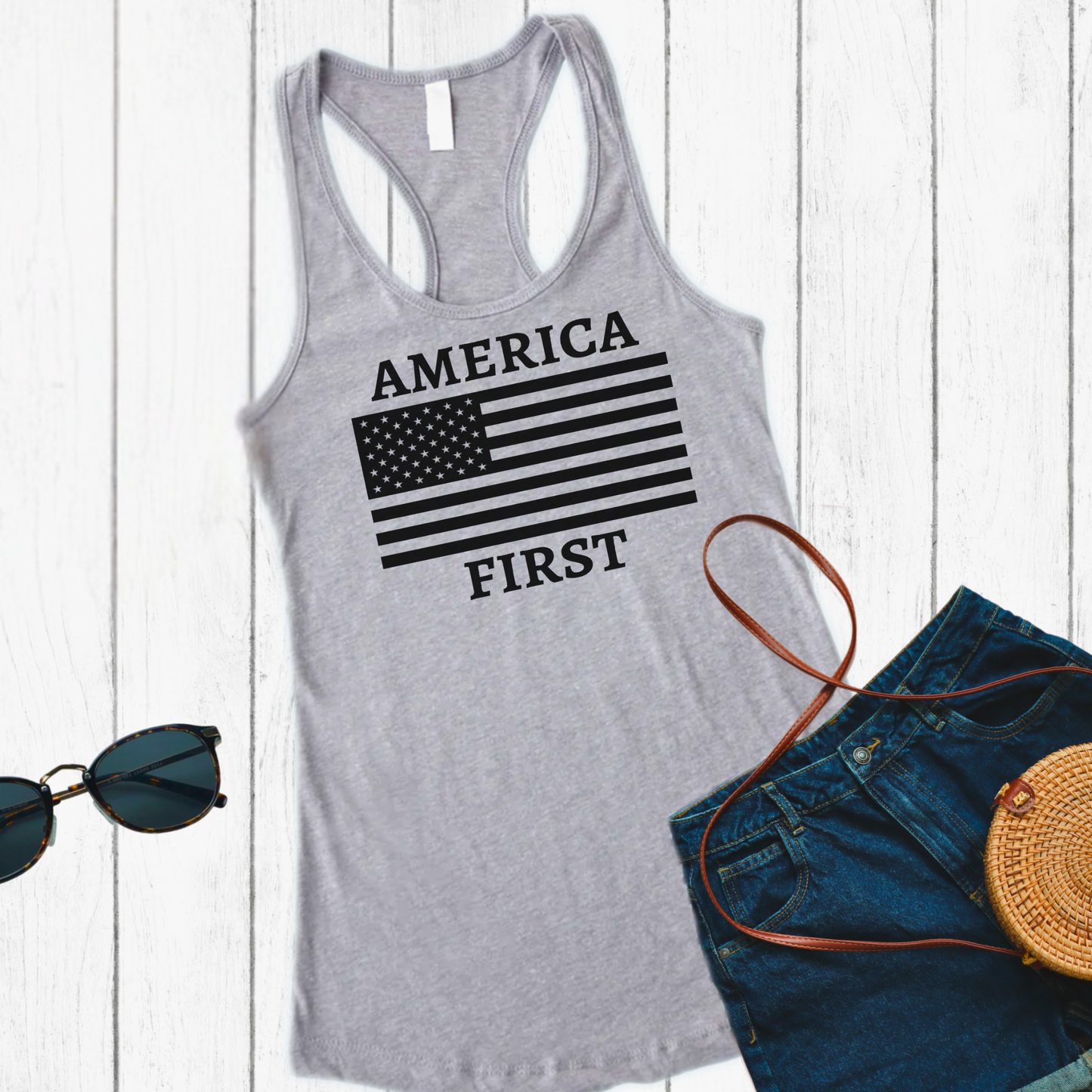 Gray racerback tank styled with shorts and sunglasses, featuring black America First flag print