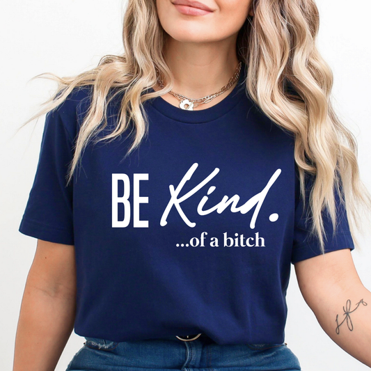 Woman wearing a navy blue t-shirt with 'BE KIND...of a bitch' text.