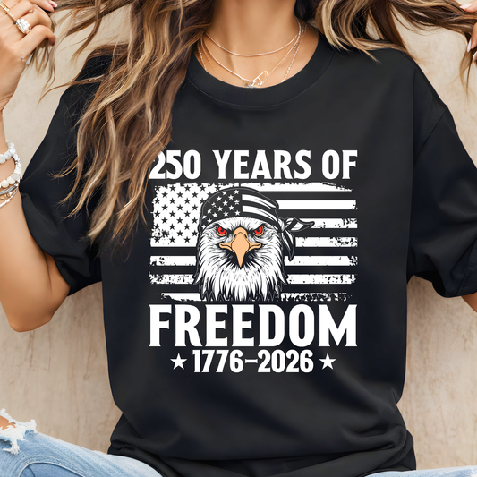 Woman wearing a black t-shirt with an eagle graphic and text celebrating 250 years of freedom.