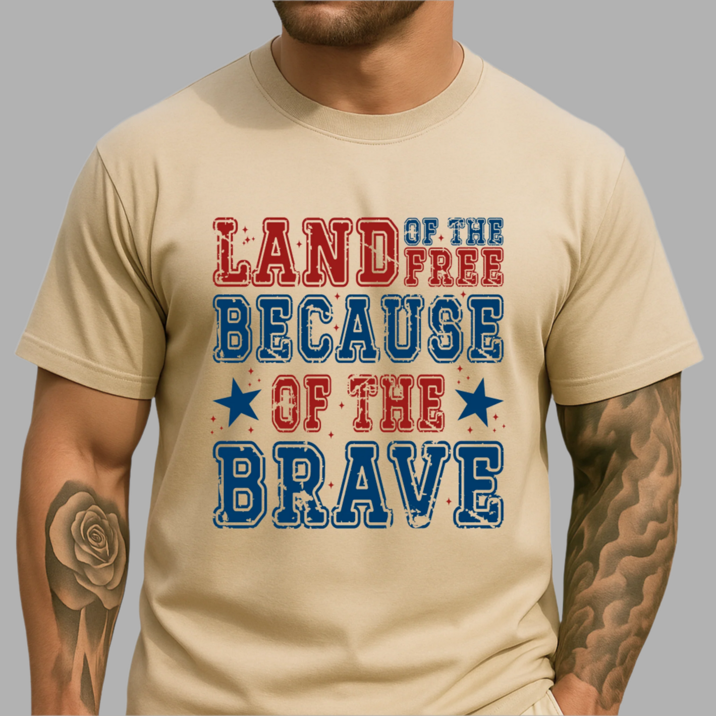 Man wearing tan patriotic T-shirt with “Land of the Free Because of the Brave” design