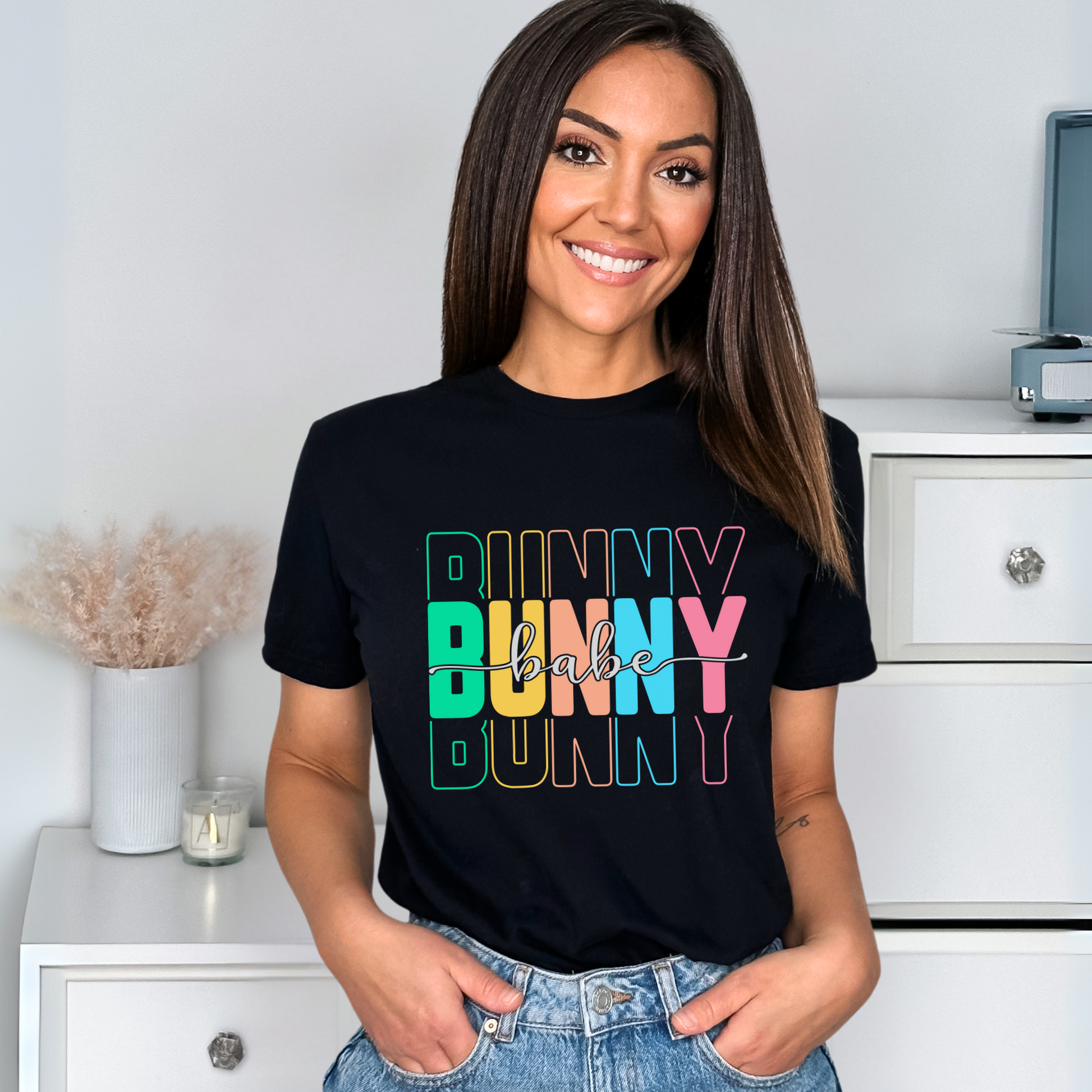 Trendy Bunny Babe graphic t-shirt with colorful pastel typography, perfect for Easter outfits, spring fashion, and casual wear. Soft cotton tee for women.