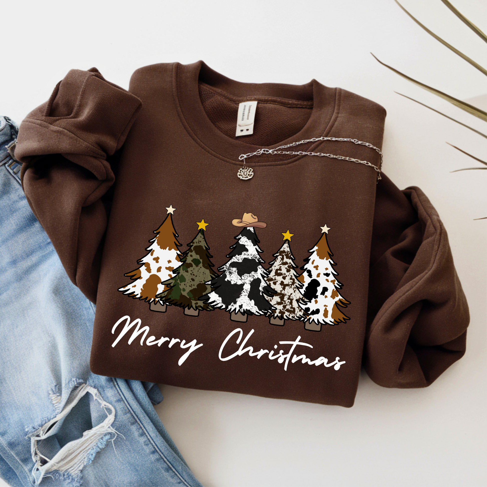 Brown sweatshirt with Country Cow Christmas tree design and 'Merry Christmas' text on a white background