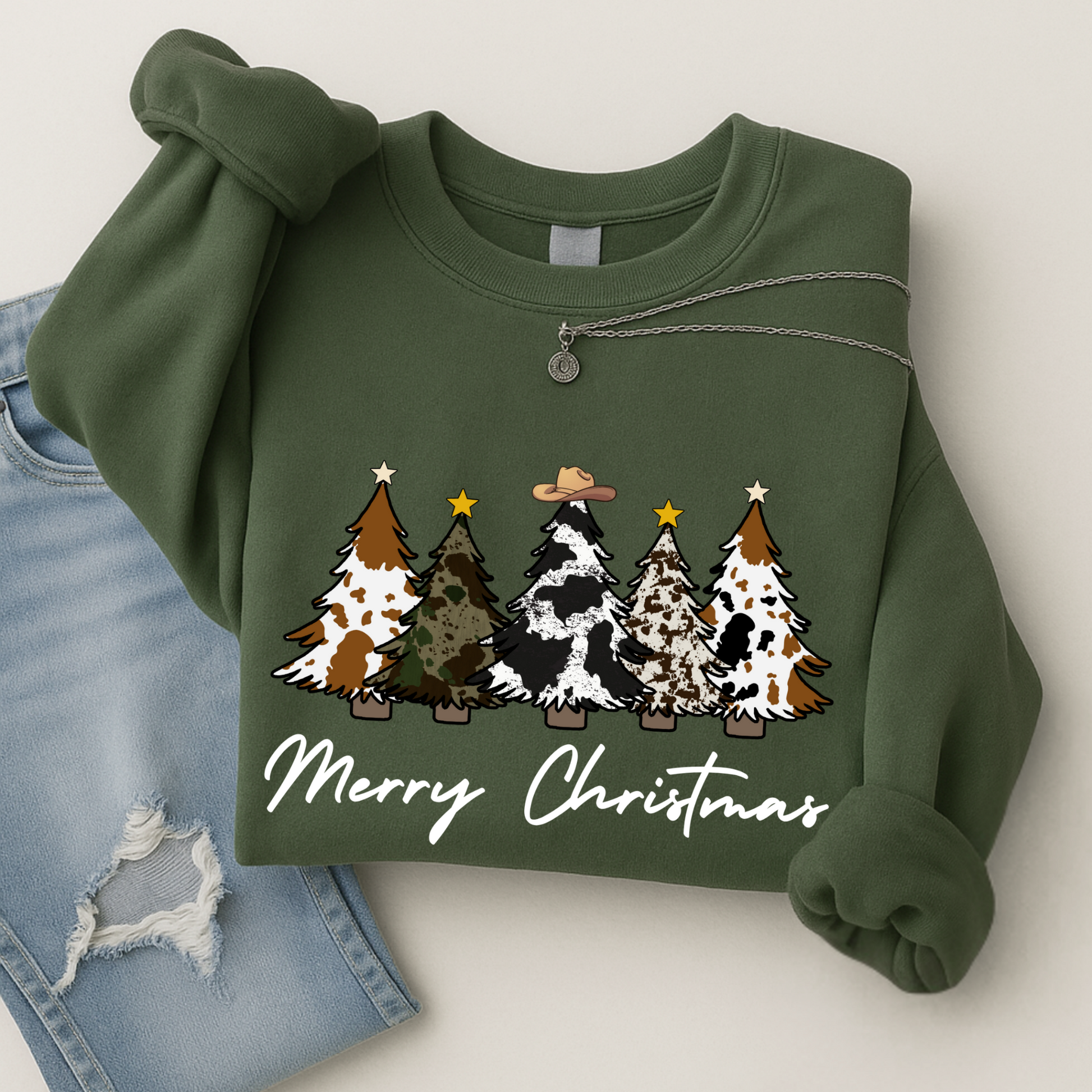 Green sweatshirt with Western Christmas tree design and 'Merry Christmas' text on a white background