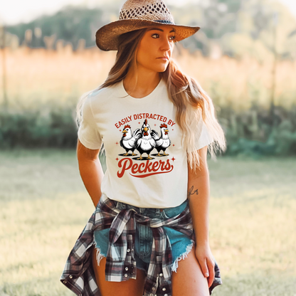  Woman wearing a White T-shirt with "Easily Distracted by Peckers" text and three funny chickens design. Perfect for chicken lovers and humor enthusiasts