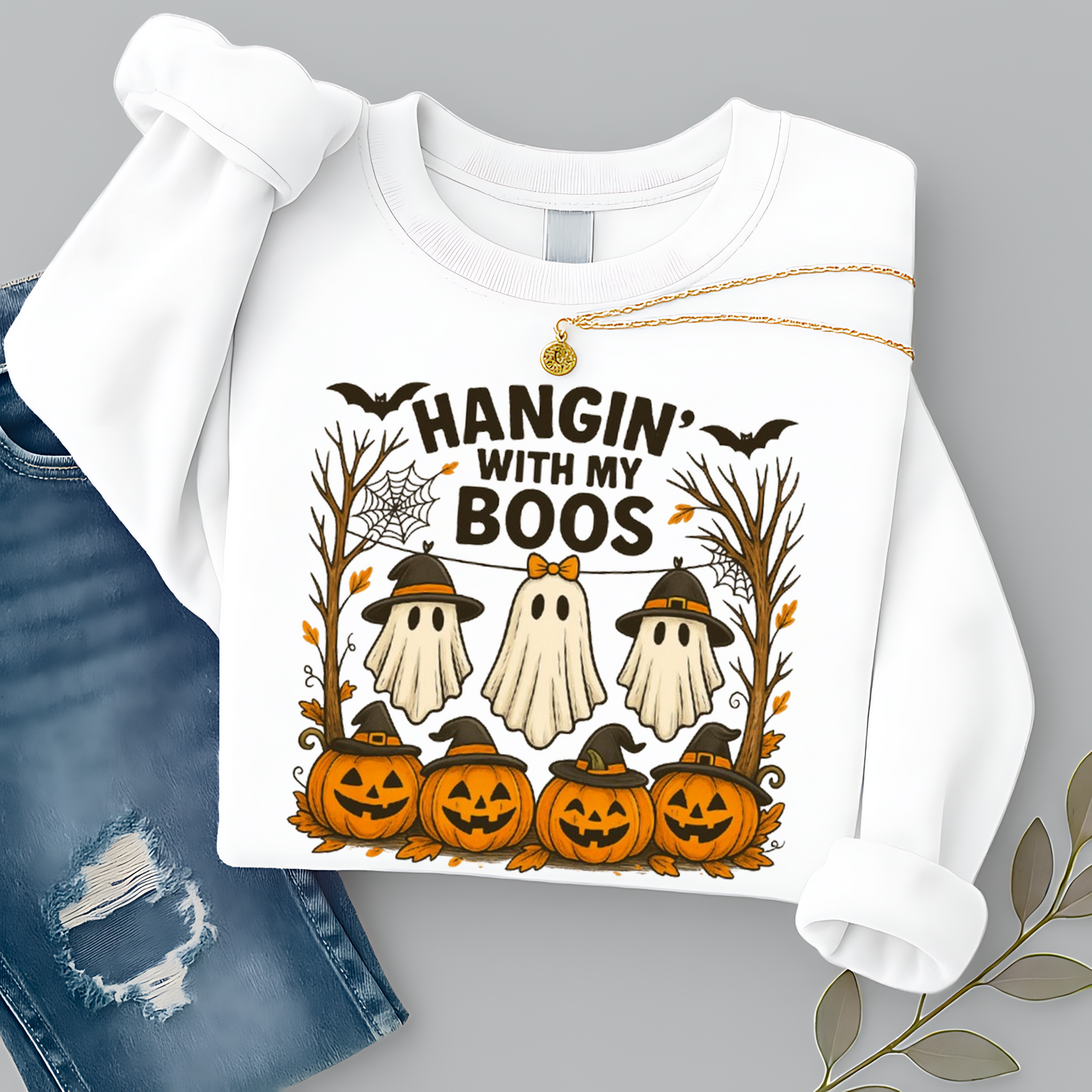 White Hangin’ With My Boos sweatshirt showcasing three ghosts, pumpkins, bats, and autumn trees. Unisex Halloween crewneck styled with cozy fall outfit vibes.