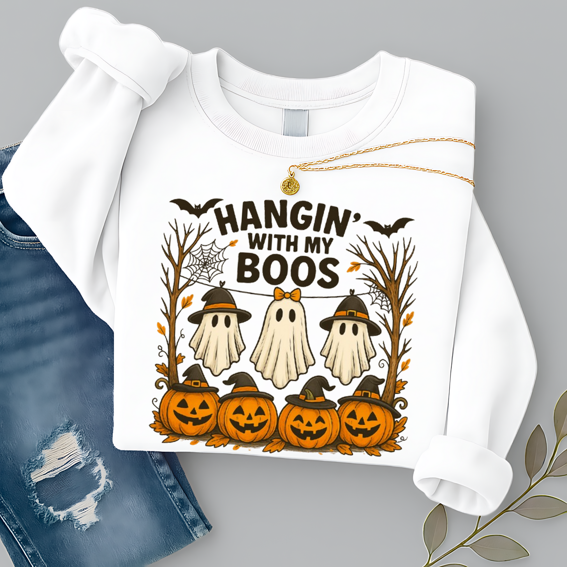 White Hangin’ With My Boos sweatshirt showcasing three ghosts, pumpkins, bats, and autumn trees. Unisex Halloween crewneck styled with cozy fall outfit vibes.