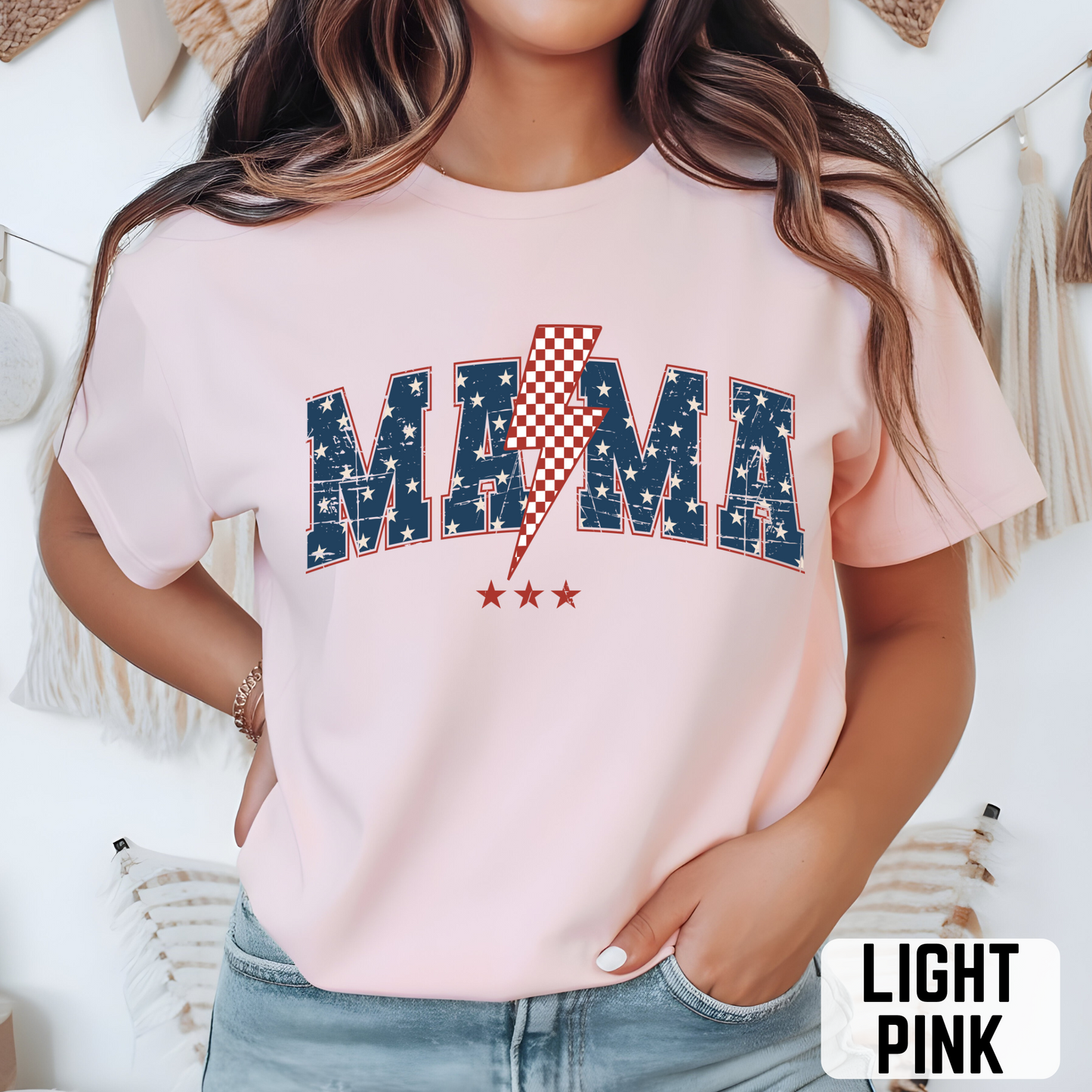 Light pink MAMA USA T-shirt with blue star letters and bold red lightning bolt,
