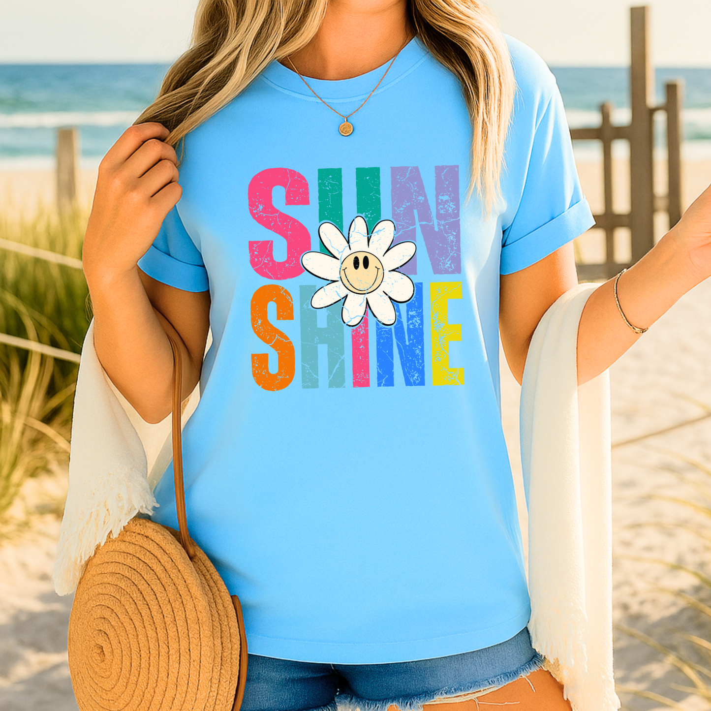 Sky Blue Tshirt with block letters reading "Sunshine" with a flower