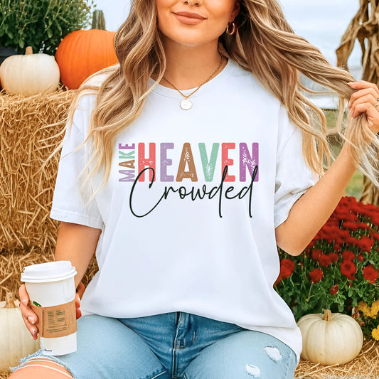 Woman outdoors in white Make Heaven Crowded T-shirt holding coffee at pumpkin patch