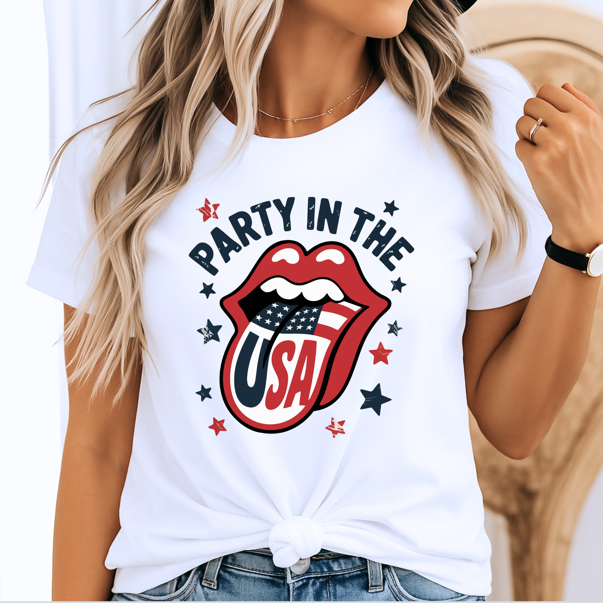 Woman wearing a white “Party in the USA” T-shirt with bold patriotic lips and flag tongue design, styled with a front knot. Perfect for 4th of July BBQs, Memorial Day events, and summer USA pride outfits.


